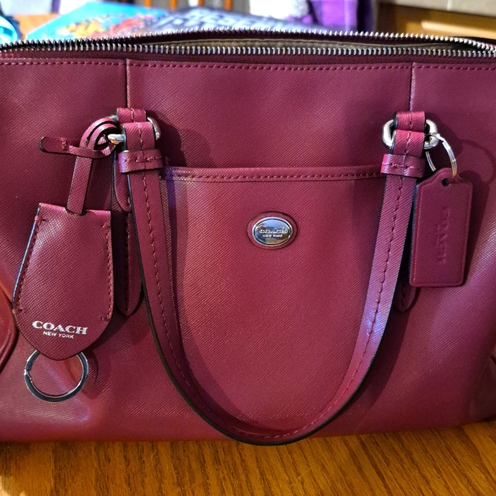 Coach satchel with shoulder strap. Color is merlot.